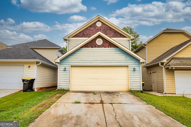 traditional home featuring a front yard, driveway, and a garage
