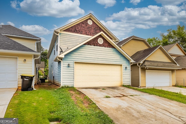 view of front of property featuring a front yard, concrete driveway, and roof with shingles