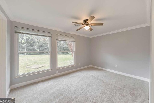 unfurnished room featuring baseboards, light carpet, a ceiling fan, and ornamental molding