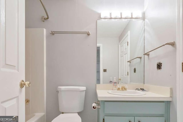 full bathroom with toilet and vanity