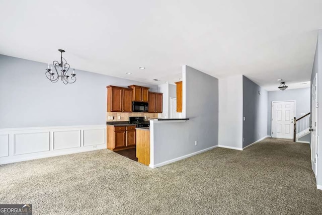 2872 Cross Creek Ct, Cumming, GA 30040 - kitchen featuring black appliances, brown cabinets, an inviting chandelier, baseboards, and dark colored carpet