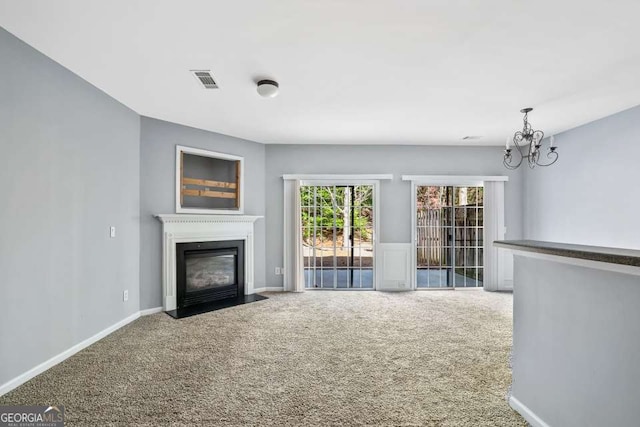 2872 Cross Creek Ct, Cumming, GA 30040 - unfurnished living room featuring a fireplace with flush hearth, a notable chandelier, visible vents, and carpet