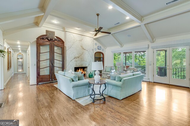 2436 Hawthorne Ln, Gainesville, GA 30506 - living area with a premium fireplace, a ceiling fan, french doors, visible vents, and lofted ceiling with beams
