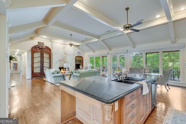 2436 Hawthorne Ln, Gainesville, GA 30506 - kitchen featuring ceiling fan, a high end fireplace, light wood-style floors, a center island with sink, and light brown cabinetry