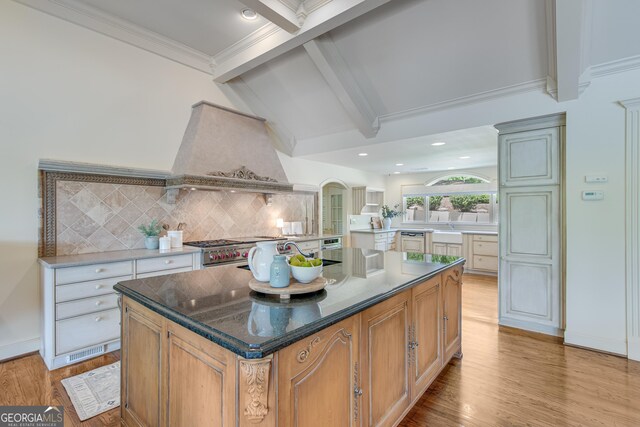 2436 Hawthorne Ln, Gainesville, GA 30506 - kitchen with premium range hood, light wood-style floors, backsplash, stainless steel stove, and a center island