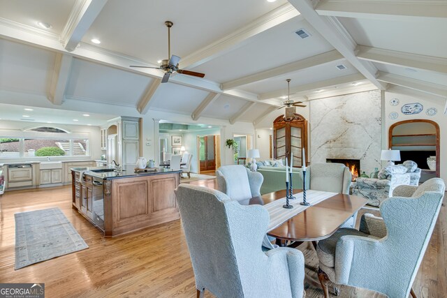 2436 Hawthorne Ln, Gainesville, GA 30506 - dining area featuring ceiling fan, light wood-style floors, and a high end fireplace