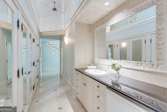 2436 Hawthorne Ln, Gainesville, GA 30506 - bathroom featuring a ceiling fan, baseboards, ornamental molding, tile patterned floors, and vanity