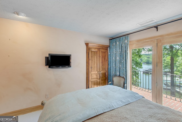 2436 Hawthorne Ln, Gainesville, GA 30506 - bedroom featuring a textured ceiling, visible vents, and access to outside