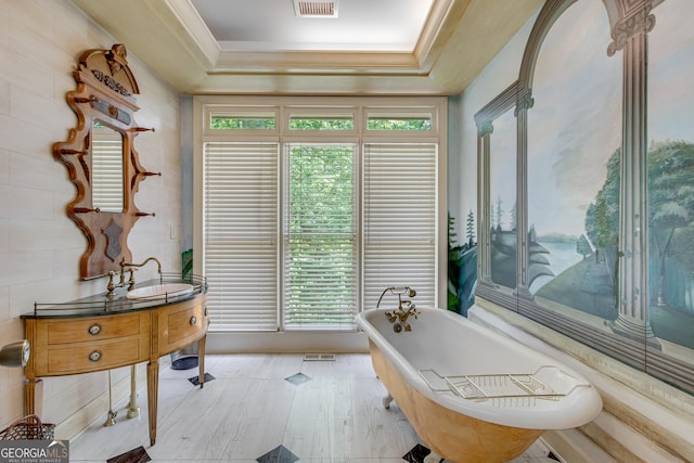 2436 Hawthorne Ln, Gainesville, GA 30506 - bathroom with wood finished floors, a soaking tub, visible vents, a raised ceiling, and vanity