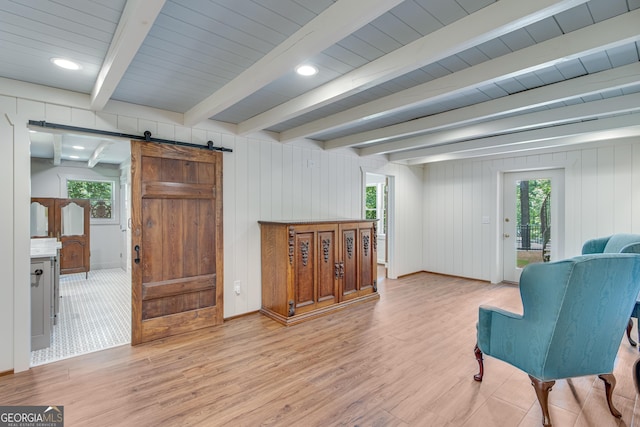 2436 Hawthorne Ln, Gainesville, GA 30506 - living area featuring a wealth of natural light, light wood-type flooring, a barn door, and beam ceiling