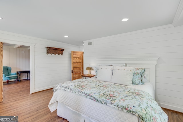2436 Hawthorne Ln, Gainesville, GA 30506 - bedroom featuring baseboards, crown molding, visible vents, and wood finished floors