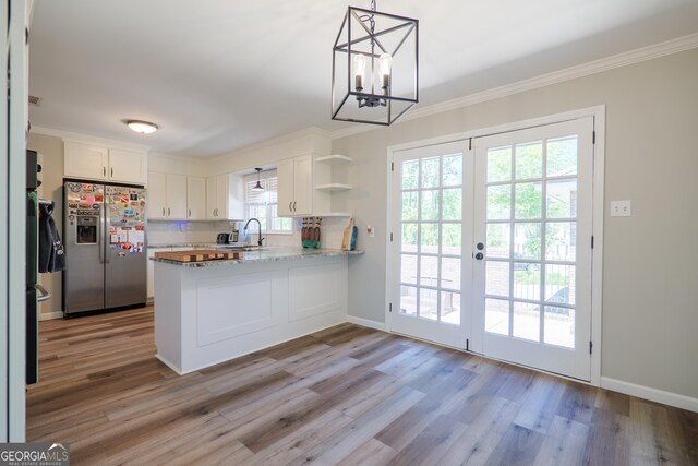 kitchen with white cabinets, stainless steel fridge with ice dispenser, open shelves, and light wood-style flooring