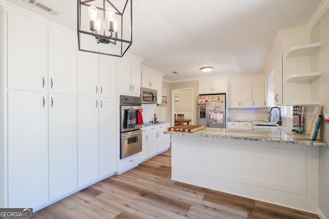 kitchen with open shelves, a sink, stainless steel appliances, light wood finished floors, and visible vents