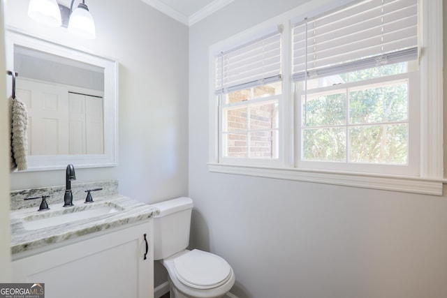 bathroom featuring crown molding, vanity, and toilet
