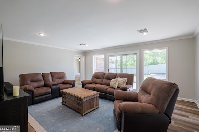 living room with baseboards, ornamental molding, wood finished floors, and recessed lighting
