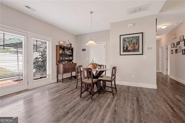 1129 Abundance Dr, Locust Grove, GA 30248 - dining space with dark wood-type flooring, visible vents, and baseboards