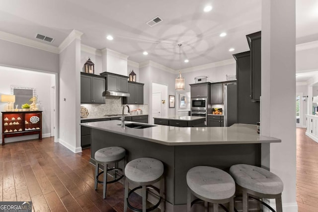 4815 Amble Trce, Cumming, GA 30040 - kitchen with stainless steel appliances, a sink, a center island, ornamental molding, and recessed lighting