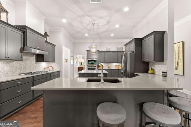 4815 Amble Trce, Cumming, GA 30040 - kitchen with stainless steel appliances, a sink, crown molding, under cabinet range hood, and a peninsula