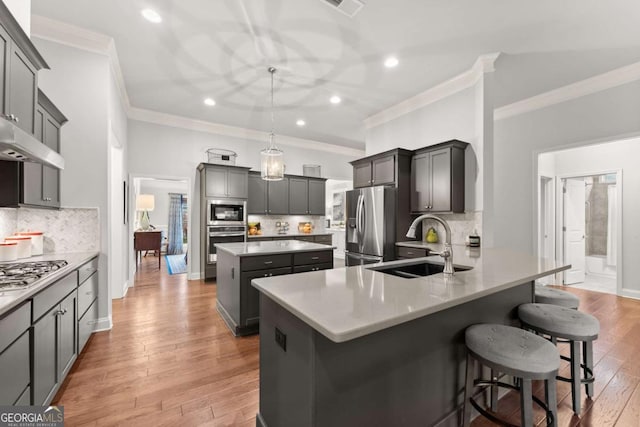 4815 Amble Trce, Cumming, GA 30040 - kitchen with crown molding, stainless steel appliances, a sink, a breakfast bar, and decorative backsplash