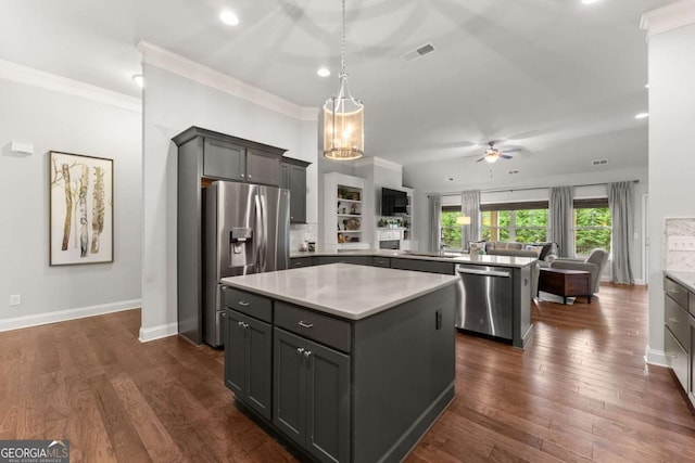 4815 Amble Trce, Cumming, GA 30040 - kitchen featuring appliances with stainless steel finishes, a peninsula, ceiling fan, a kitchen island, and light countertops