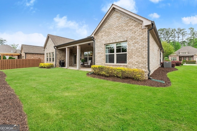 4815 Amble Trce, Cumming, GA 30040 - rear view of house with cooling unit, a patio area, and brick siding