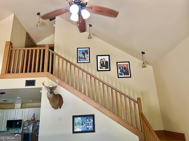 54 Lodge Ground Ln, Hawkinsville, GA 31036 - stairway with vaulted ceiling, visible vents, and a ceiling fan