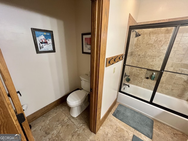 54 Lodge Ground Ln, Hawkinsville, GA 31036 - bathroom with shower / bath combination with glass door, stone finish floor, toilet, and baseboards