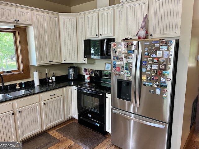 54 Lodge Ground Ln, Hawkinsville, GA 31036 - kitchen featuring a sink, stainless steel fridge, dark stone countertops, black range with electric cooktop, and wood finished floors