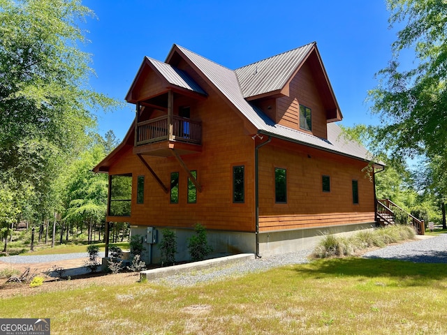 54 Lodge Ground Ln, Hawkinsville, GA 31036 - view of property exterior featuring a yard, a balcony, and metal roof