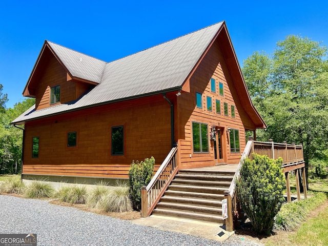 54 Lodge Ground Ln, Hawkinsville, GA 31036 - view of side of property featuring a wooden deck, stairs, and metal roof