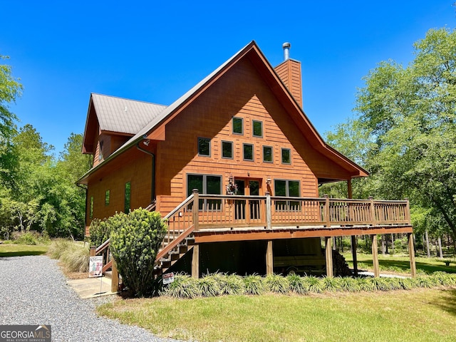 54 Lodge Ground Ln, Hawkinsville, GA 31036 - back of property featuring a chimney, a wooden deck, and stairway