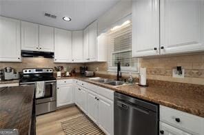 515 Walraven Rd NE, Calhoun, GA 30701 - kitchen with a sink, stainless steel electric range oven, dark countertops, dishwasher, and under cabinet range hood
