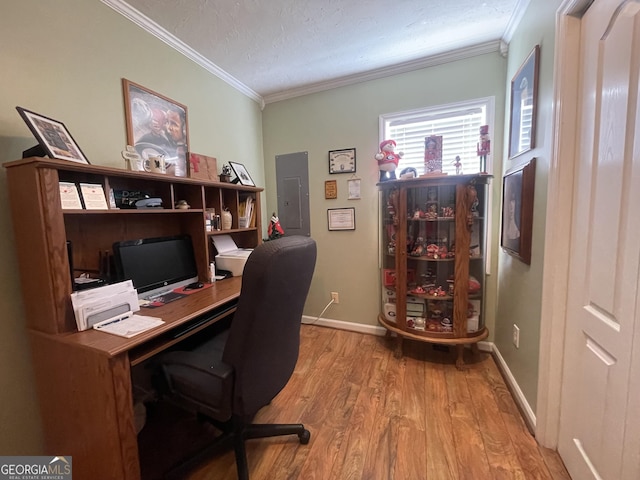 office featuring electric panel, a textured ceiling, baseboards, wood finished floors, and ornamental molding