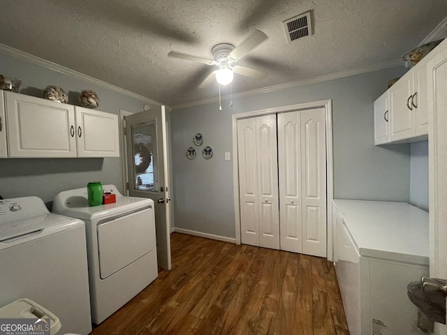 laundry room with dark wood-style floors, visible vents, a ceiling fan, cabinet space, and washer and dryer