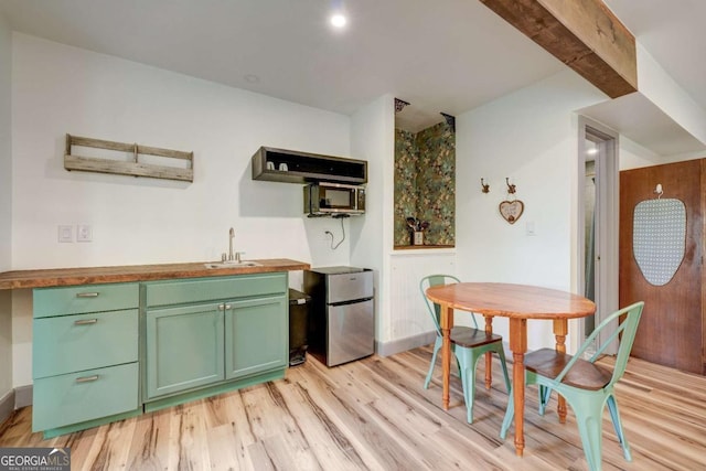 361 Rising Star Rd Unit 14, Ellijay, GA 30536 - kitchen with a sink, light wood-type flooring, freestanding refrigerator, green cabinets, and wood counters
