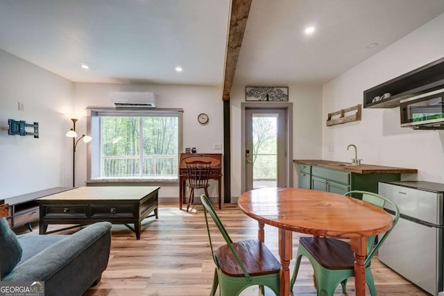 361 Rising Star Rd Unit 14, Ellijay, GA 30536 - dining area featuring a wall unit AC, light wood-style flooring, beam ceiling, and recessed lighting