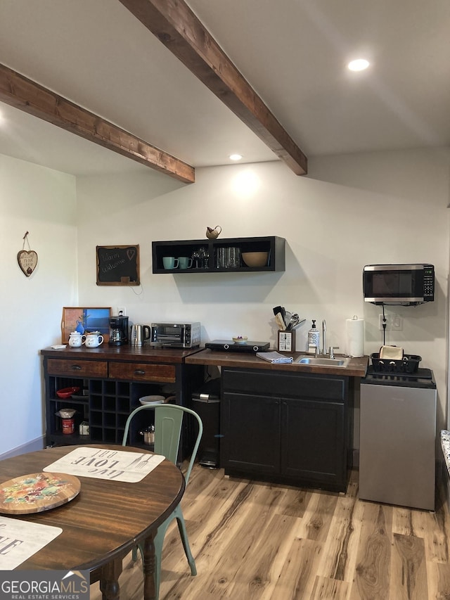 361 Rising Star Rd Unit 14, Ellijay, GA 30536 - kitchen featuring stainless steel microwave, washer / dryer, beamed ceiling, light wood-style floors, and recessed lighting