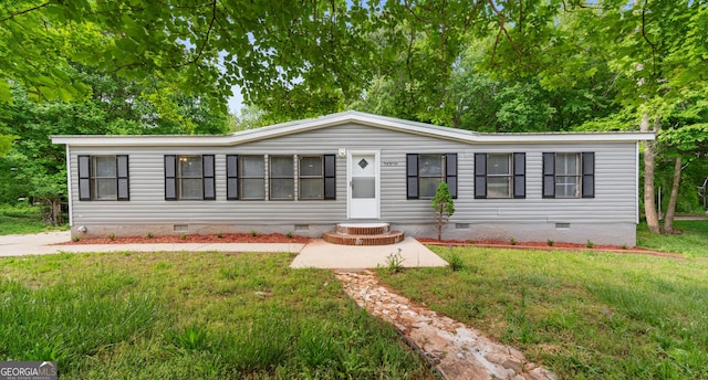 manufactured / mobile home with crawl space and a front yard
