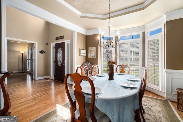 629 Gold Valley Pass, Canton, GA 30114 - dining space featuring a tray ceiling, an inviting chandelier, ornamental molding, and light wood-style floors
