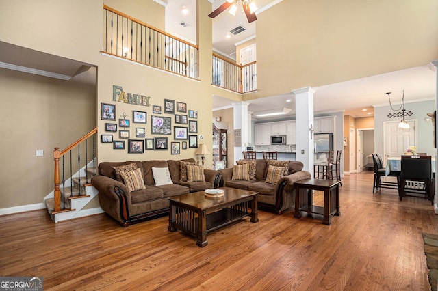 629 Gold Valley Pass, Canton, GA 30114 - living room featuring crown molding, a ceiling fan, stairs, and wood finished floors