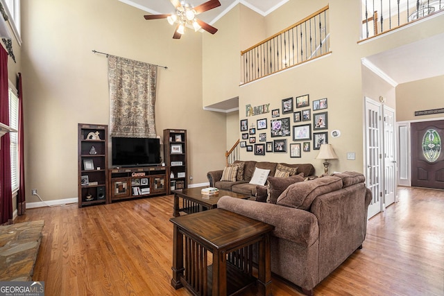 629 Gold Valley Pass, Canton, GA 30114 - living room featuring crown molding, a ceiling fan, and a towering ceiling