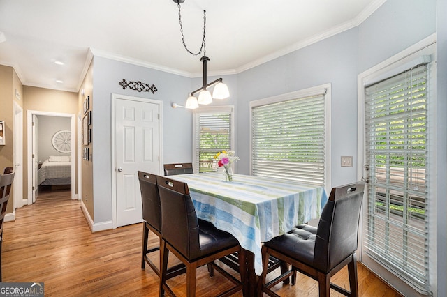 629 Gold Valley Pass, Canton, GA 30114 - dining space featuring an inviting chandelier, baseboards, ornamental molding, and light wood-style flooring