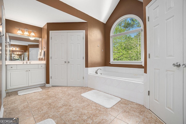 629 Gold Valley Pass, Canton, GA 30114 - full bathroom featuring vanity, a garden tub, tile patterned floors, and lofted ceiling