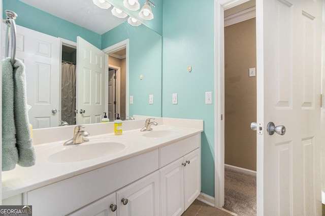 629 Gold Valley Pass, Canton, GA 30114 - bathroom featuring double vanity, a sink, baseboards, and tile patterned flooring