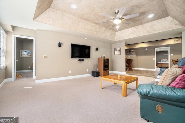 629 Gold Valley Pass, Canton, GA 30114 - living area with a ceiling fan, visible vents, light colored carpet, baseboards, and a tray ceiling