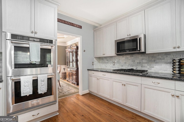 629 Gold Valley Pass, Canton, GA 30114 - kitchen featuring crown molding, decorative backsplash, light wood-style floors, and stainless steel appliances