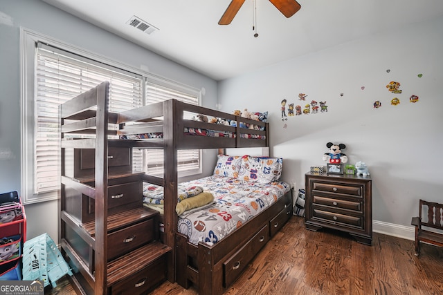 bedroom featuring wood finished floors, baseboards, and ceiling fan