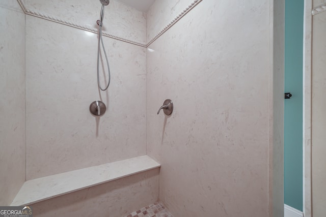 full bath featuring tiled shower