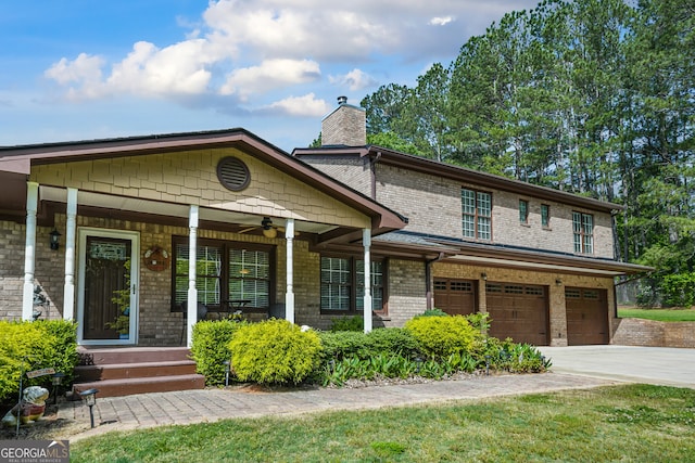 view of front of house with an attached garage, a chimney, concrete driveway, covered porch, and ceiling fan