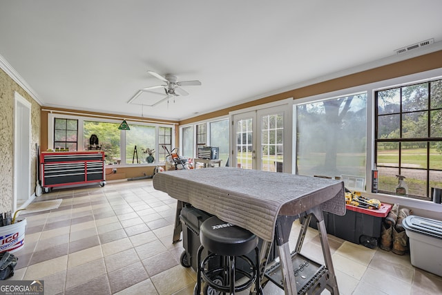 sunroom featuring french doors, crown molding, and tile patterned flooring